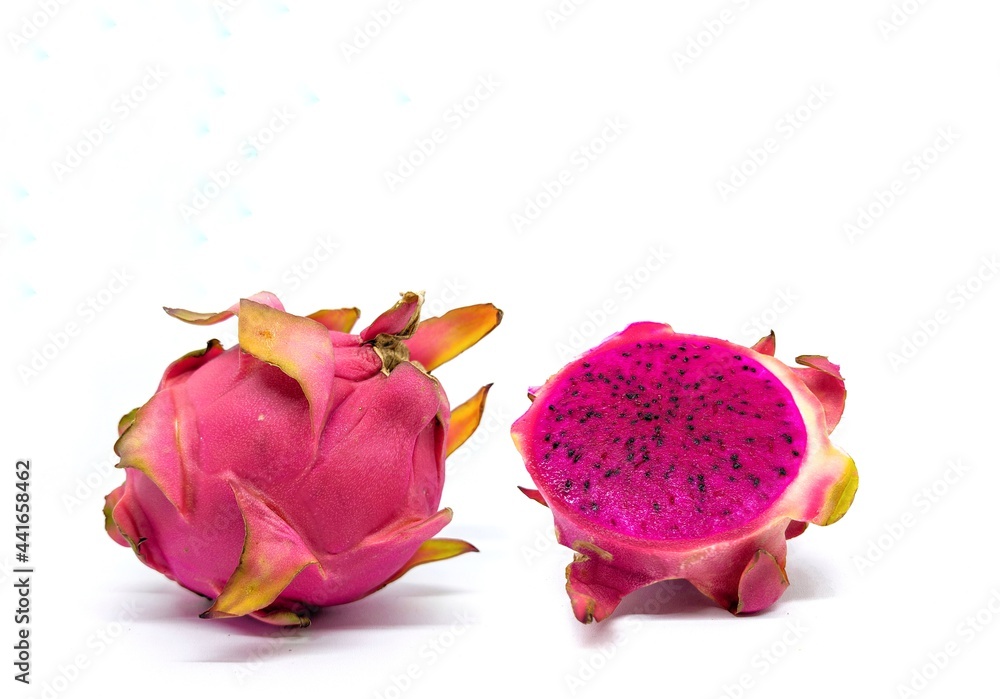 Whole and sliced fresh dragon (buah Naga) fruit on white background isolated. Whole and sliced fresh dragon (buah Naga) fruit on white background isolated.