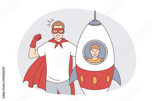 Happy fatherhood and childhood concept. Happy smiling father man in superhero costume and his son in toy rocket playing looking at camera feeling excited together vector illustration 