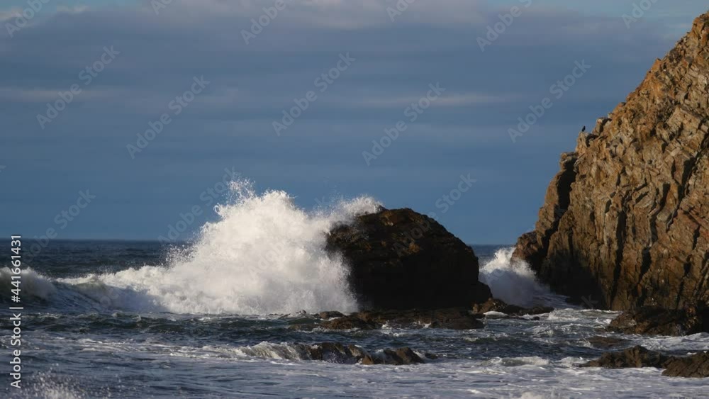 Waves crashing in slow motion against the rocks of the coast. Waves crashing in slow motion against the rocks of the coast.