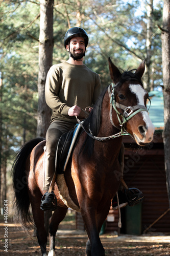 Young Man Wearing Helmet and Riding Horse