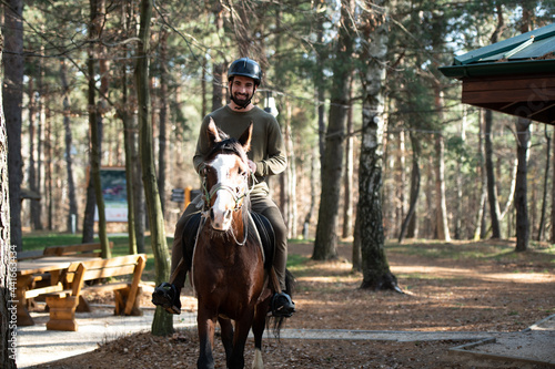 Young Man Wearing Helmet and Riding Horse