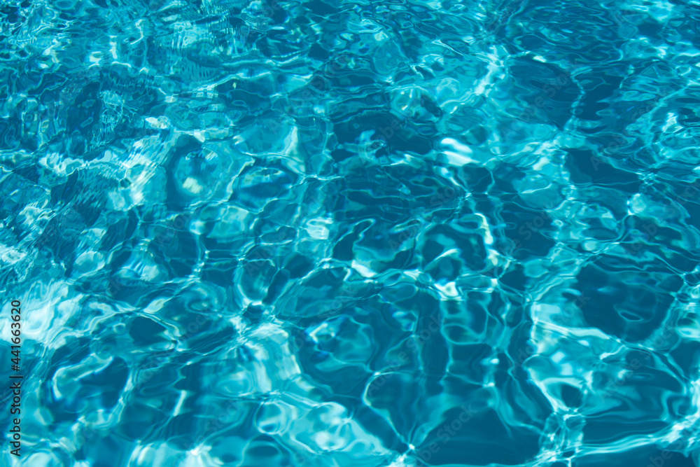 Abstract ripple wave and clear turquoise water surface in swimming pool, blue water wave for background and abstract design.
