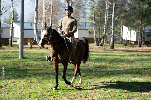 Young Man Rides a Horse Wearing a Helmet © Jale Ibrak