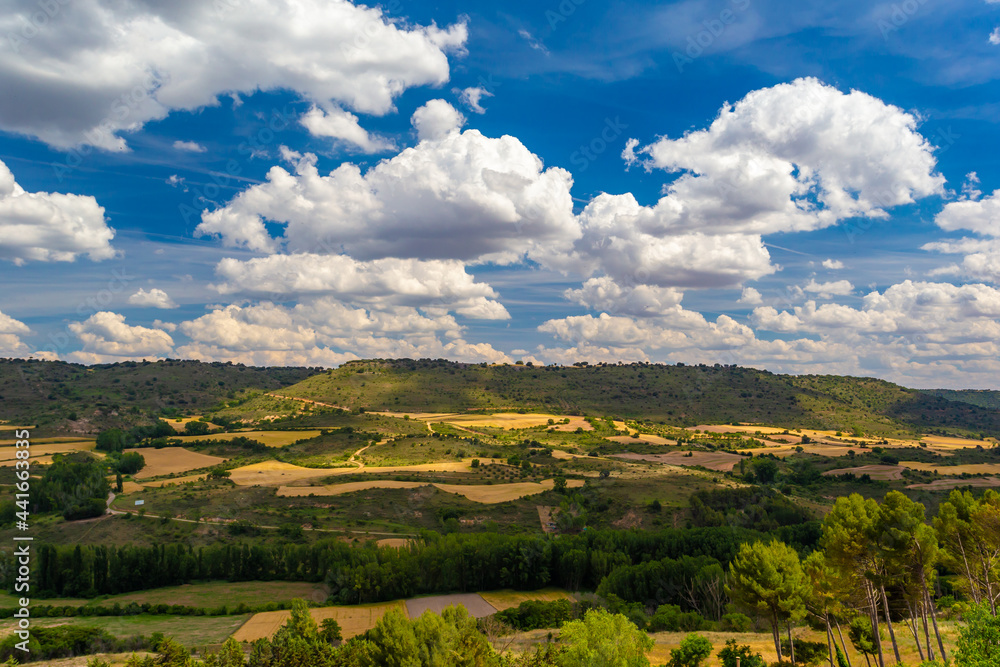 Photo landscape of the Spanish Algarve. Castile land. Landscape of Guadalajara. Harvest fields under blue sky with clouds.