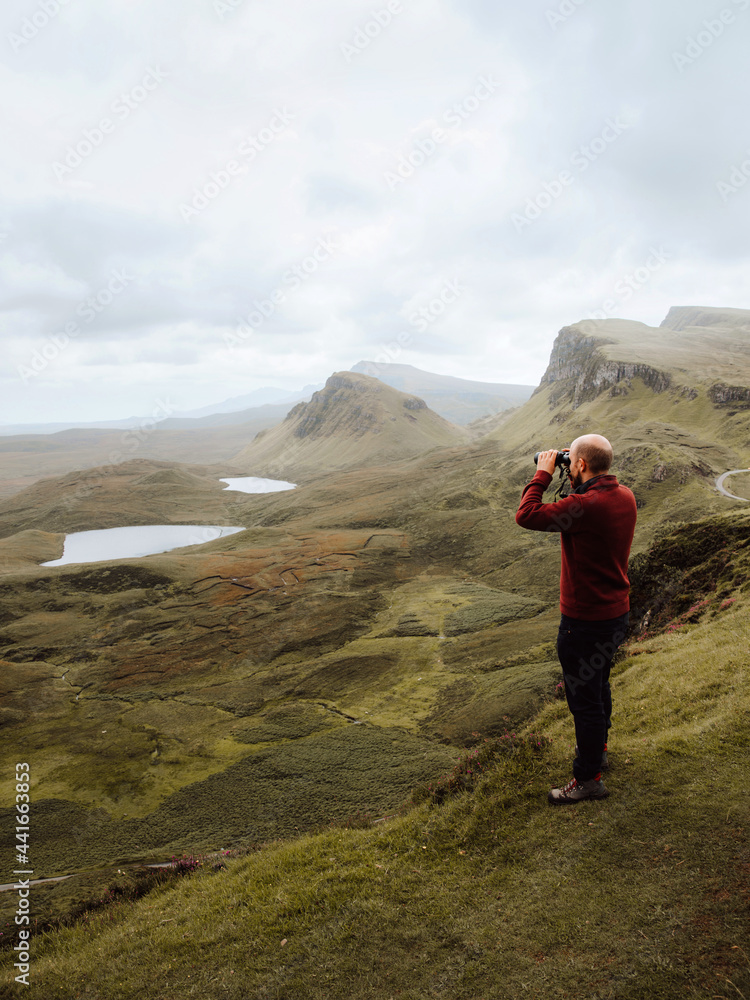 Male traveler admiring hilly terrain on cloudy day Male traveler admiring hilly terrain on cloudy day