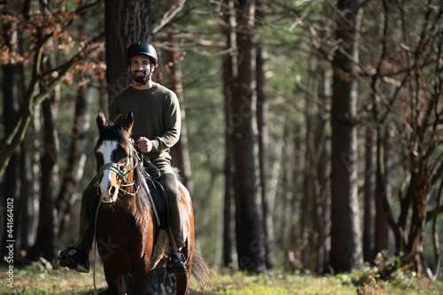 Young Man Wearing Helmet and Riding Horse