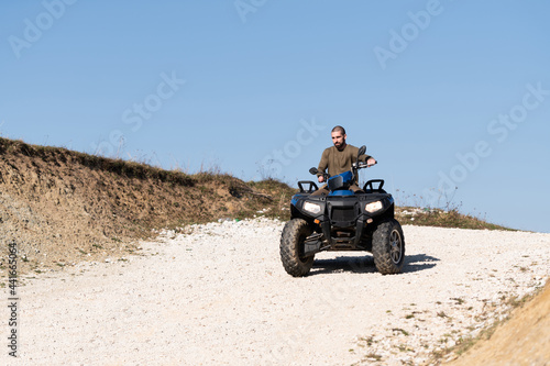 Young Guy Is Riding an Atv Outdoor