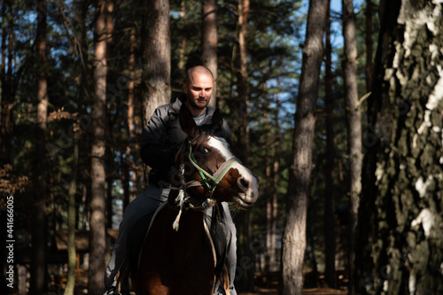Man Riding a Horse in Forest