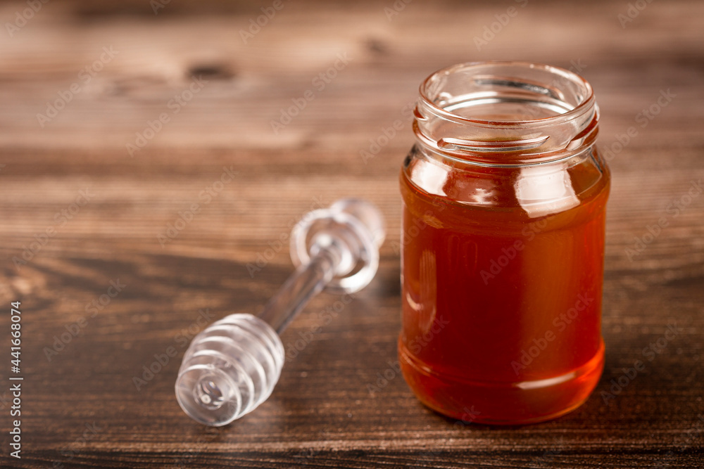 Honey in glass jar on the table. Honey in glass jar on the table.