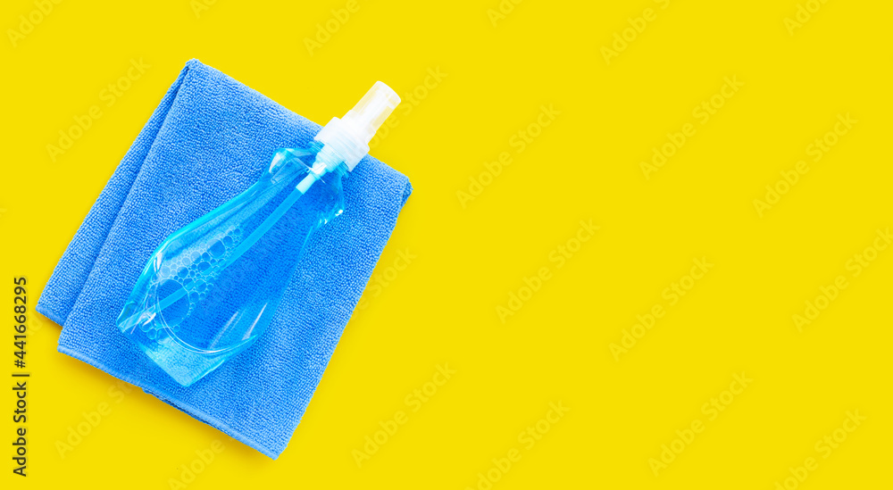 Window cleaner in plastic bottle with blue towel Window cleaner in plastic bottle with blue towel