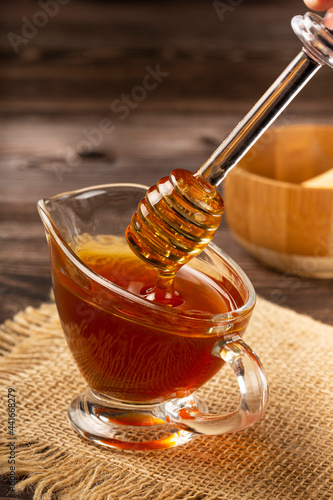 Honey in glass bowl on the table.