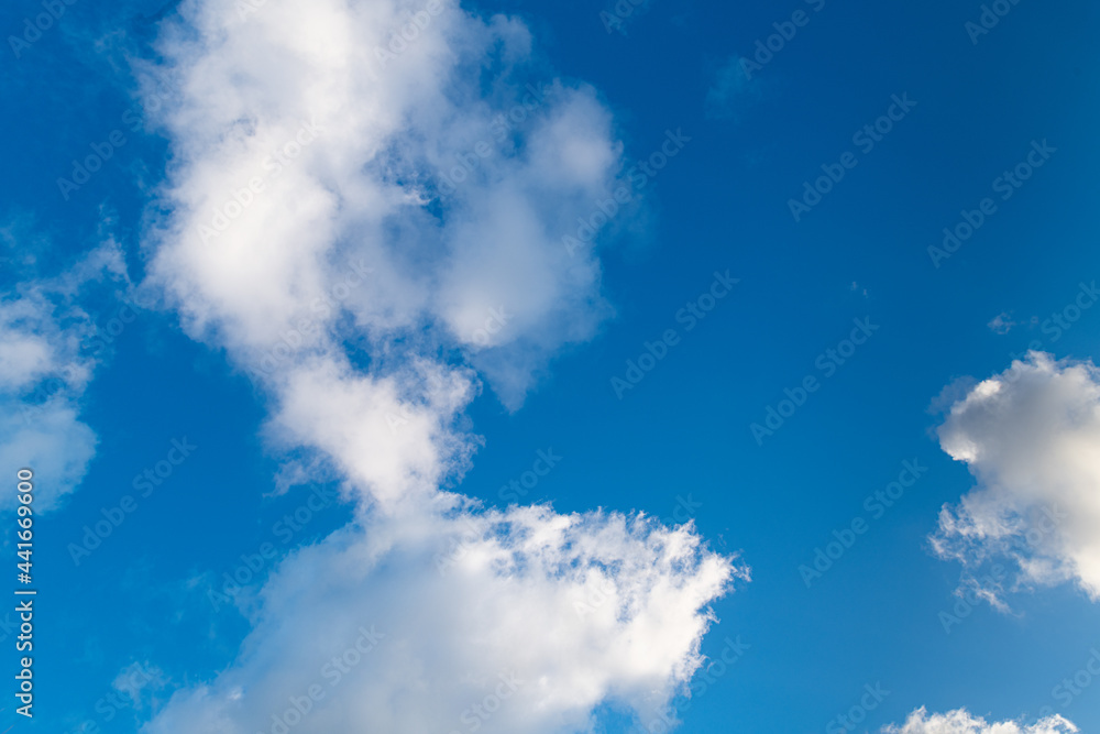 White puffy clouds against a clear blue sky White puffy clouds against a clear blue sky