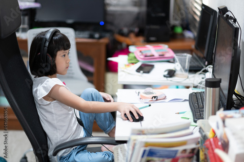Asian children is learning online computer  home school