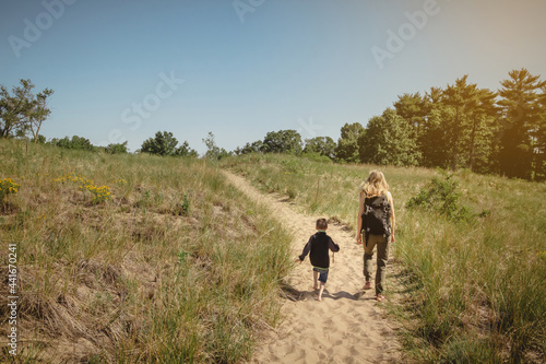 Mother and young son walking along a path at Indiana Dunes State Park © Jon