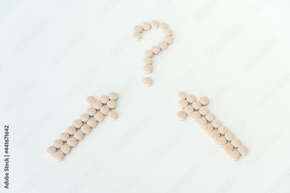 Light brown pills on white background close up top view with copy space Light brown pills on white background close up top view with copy space