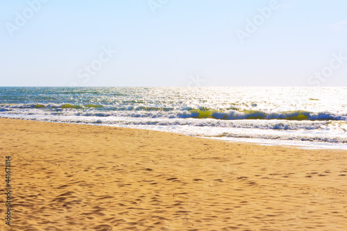 Sandy beach with sea waves . No people on the seaside