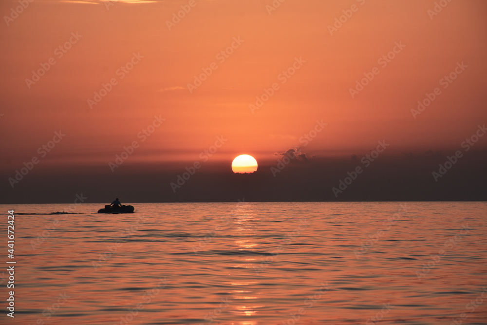 The fisherman returns home at sunset The fisherman returns home at sunset