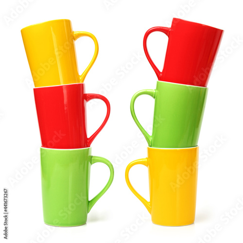 red, yellow and green cups on white background