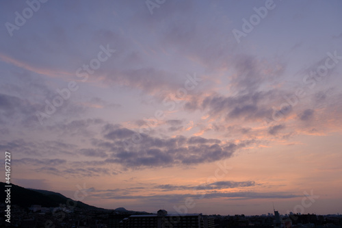 神戸市東灘区のマンション上層階から明け方の六甲山系。東の空から太陽が昇り空と雲がオレンジ色に染まる。六甲山と甲山の上雲の雲が美しい © 宮岸孝守