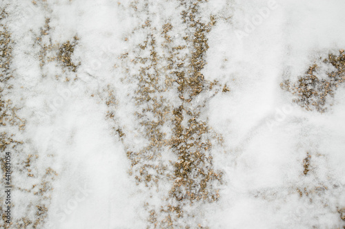 Snow covered stone surface for a Christmas backdrop. White snow, gray rock.