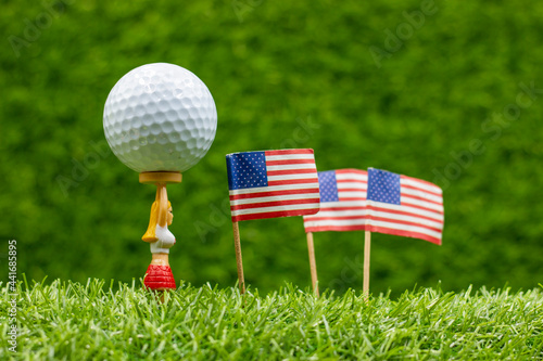 Golf Independence Day 4th July with flag of America is on green grass with caddy