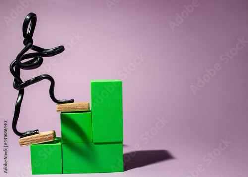 Wire man climbs stairs. Concept of self-development, learning, business growth.