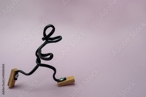 Figurine of man from wire runs.