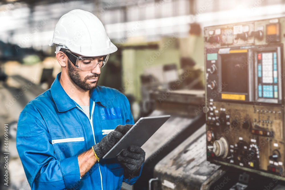 engineer setup the CNC machine with G-Code programming upload from Computer Tablet for technology in heavy industry. engineer setup the CNC machine with G-Code programming upload from Computer Tablet for technology in heavy industry.