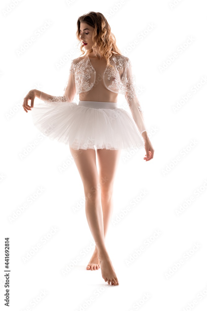Naklejka premium Barefoot ballerina in translucent shrug touching skirt