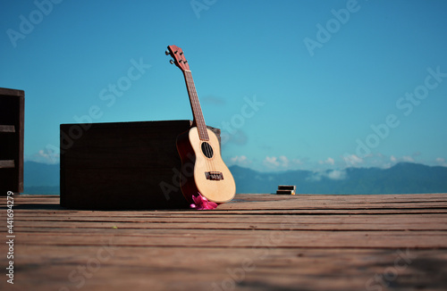 Wallpaper Mural Ukulele guitar on wooden table over the sky Torontodigital.ca