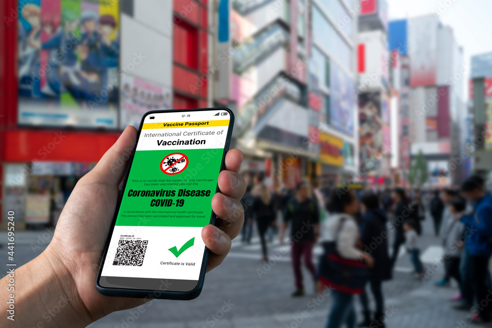 Traveler holds vaccine passport certificate to show COVID 19