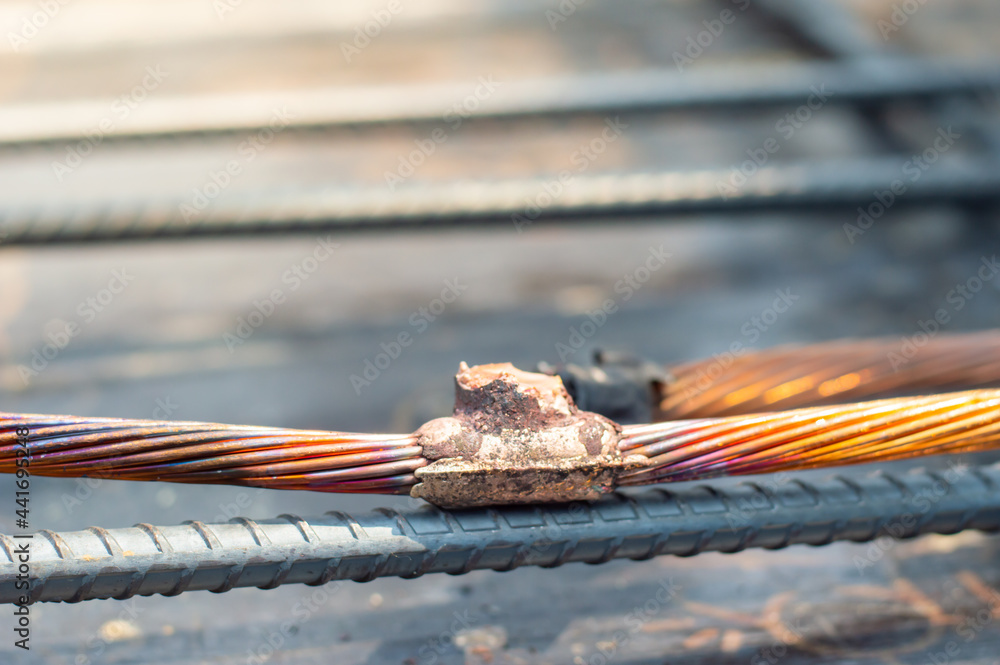 Welding copper ground wire on ground rod.Welding copper ground wire