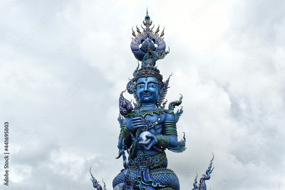 Sculptures of Chiang Rai Blue Temple or Wat Rong Seua Ten, Thai folklore and streaks of metallic gold, all contributing to the temple’s magnificence.