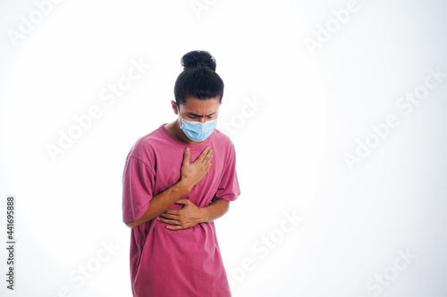 Covid19, the concept of health care and medicine. A young man standing in a face mask with hand gesture 
