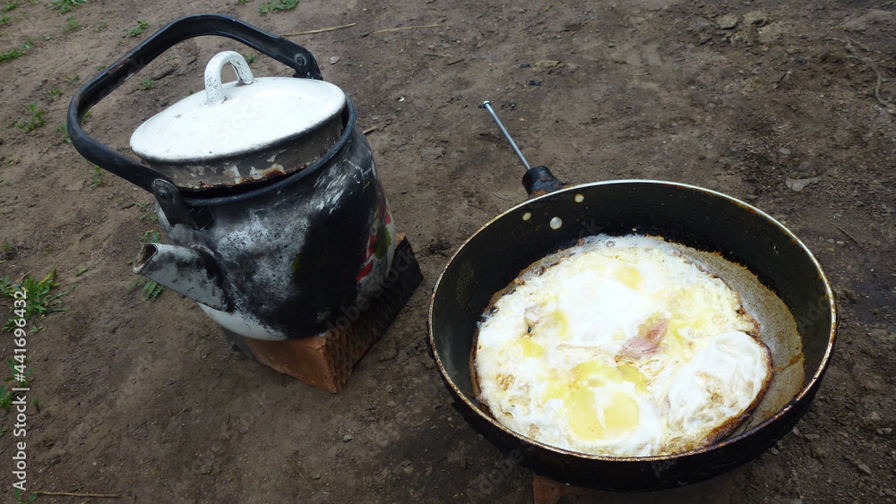 Fried scrambled eggs and boiled kettle of water Fried scrambled eggs and boiled kettle of water
