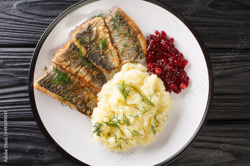 Bilde på lerret Delicious Fried herring fillet with dill garnished with mashed potatoes and lingonberry sauce close-up in a plate on the table