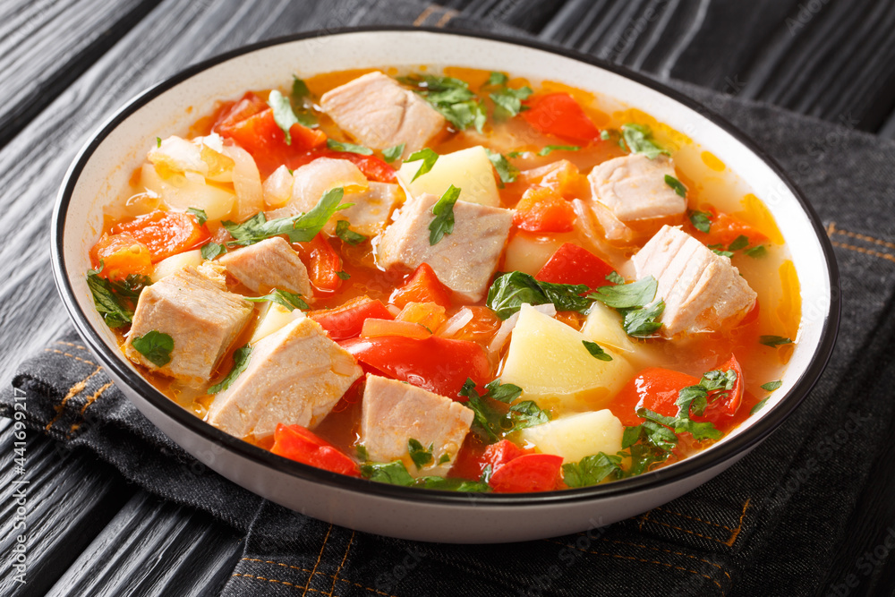 Spanish fresh tuna soup with vegetables close-up in a plate on the table. horizontal Spanish fresh tuna soup with vegetables close-up in a plate on the table. horizontal