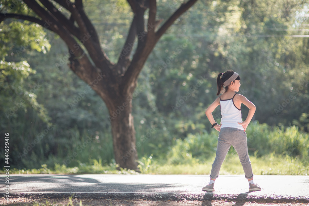 A little girl exercising in sunny bright light. A little girl exercising in sunny bright light.