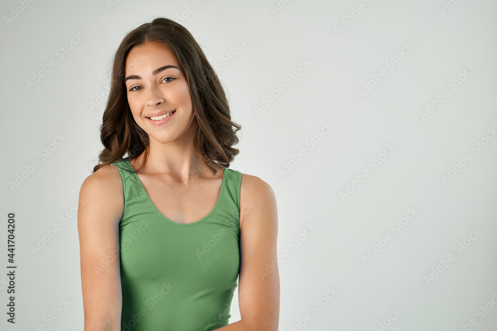 pretty brunette wearing green tank top fashion hairstyle smile cropped view pretty brunette wearing green tank top fashion hairstyle smile cropped view
