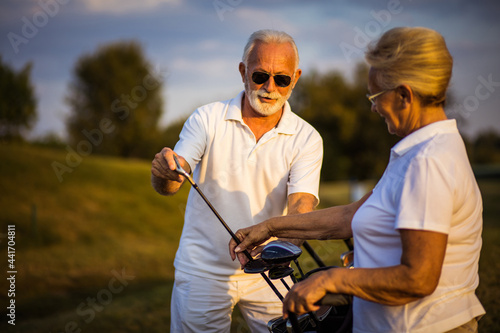 Photography Seniors golfers on the filed talking.