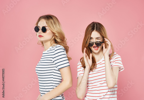funny girlfriends emotion sunglasses fashion pink background © SHOTPRIME STUDIO
