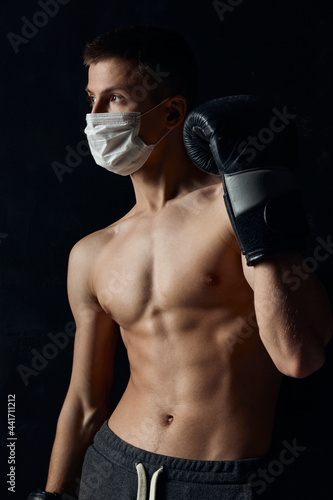 athlete in a medical mask coronavirus black background boxing gloves fitness © SHOTPRIME STUDIO