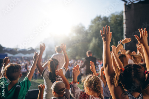 Group of fans gathered at thge stadium cheering up photo