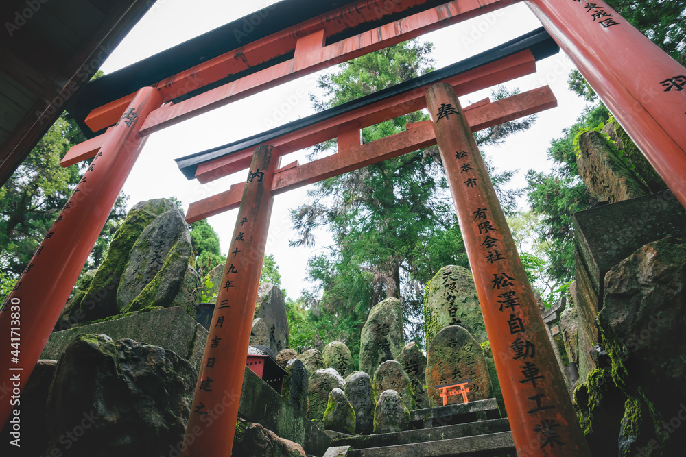 Mystical stone temple shrine covered with moss and surrounded by torii gates at Fishimi Inari Taisha in Kyoto, Japan Mystical stone temple shrine covered with moss and surrounded by torii gates at Fishimi Inari Taisha in Kyoto, Japan