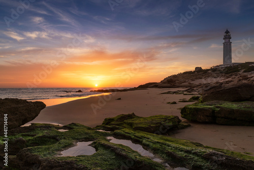 Atardecer en la playa del faro de Trafalgar en Caños de Meca, Provincia de Cádiz, Andalucía, España photo