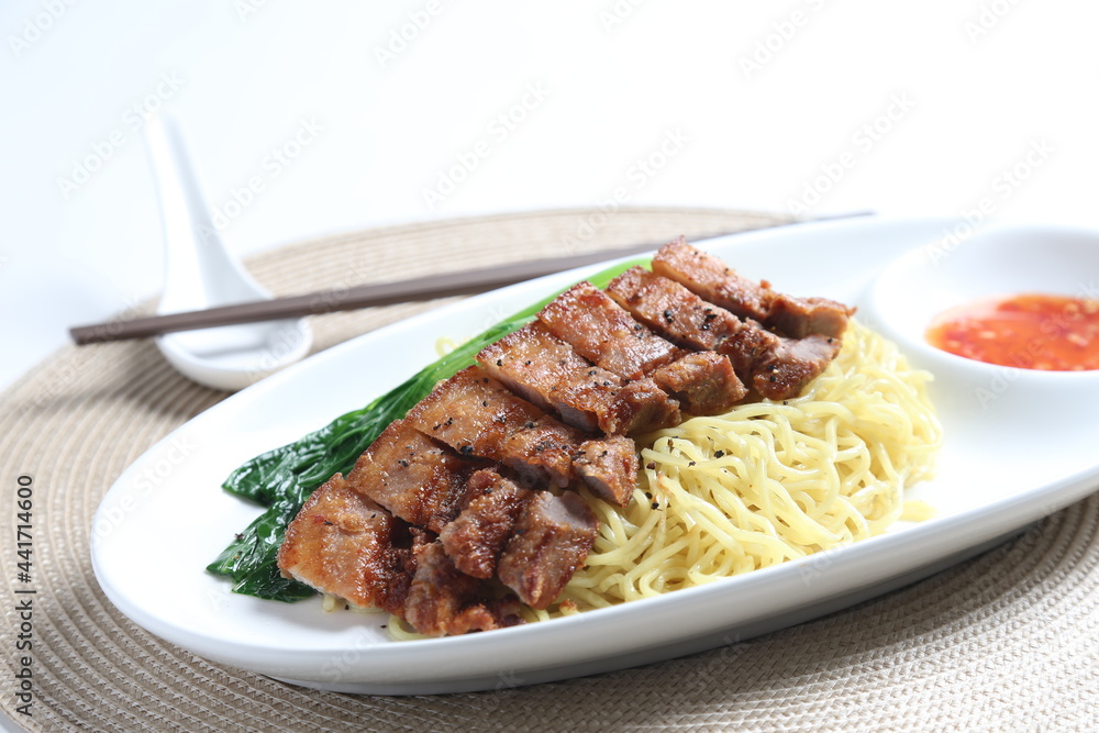 chef cook dry noodle mee with grilled chicken chop, pork cutlet and vegetable in soy sauce and chilli sauce asian halal menu