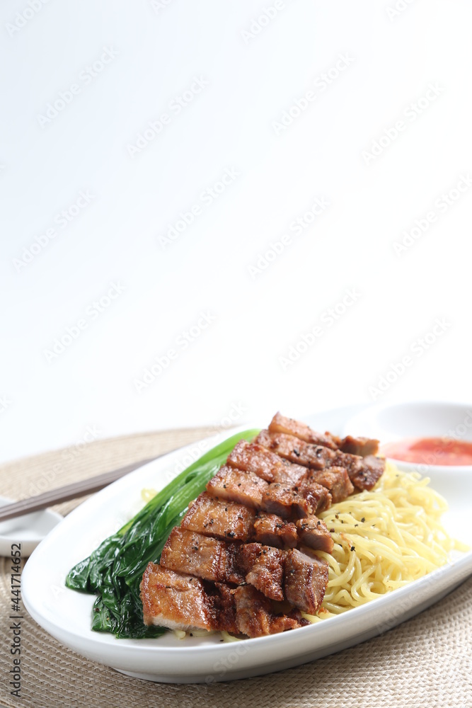 chef cook dry noodle mee with grilled chicken chop, pork cutlet and vegetable in soy sauce and chilli sauce asian halal menu