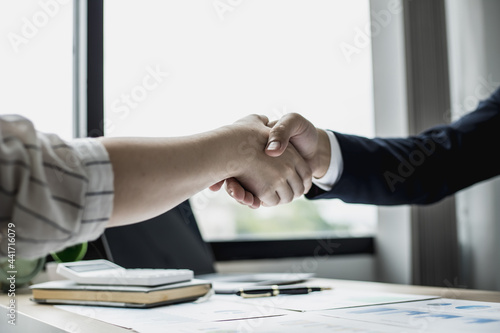 Two businessmen shake hands, they are startup friends together, business partners shake hands after brainstorming and planning a startup company. The management concept of a startup company.