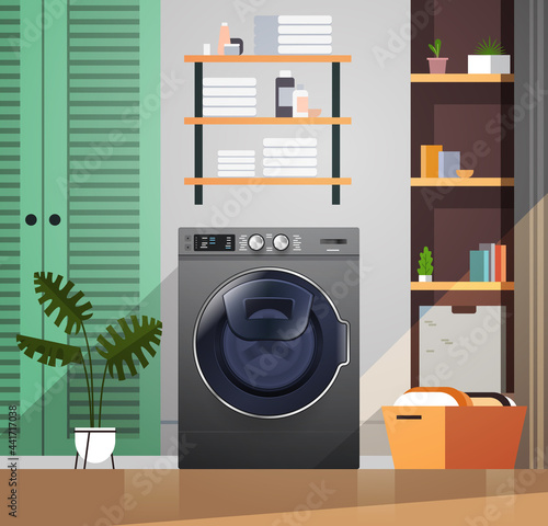 interior of laundry room with washing machine electric washer home appliance concept