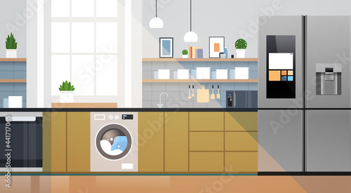modern kitchen interior with refrigerator microvawe oven and washing machine home appliances concept